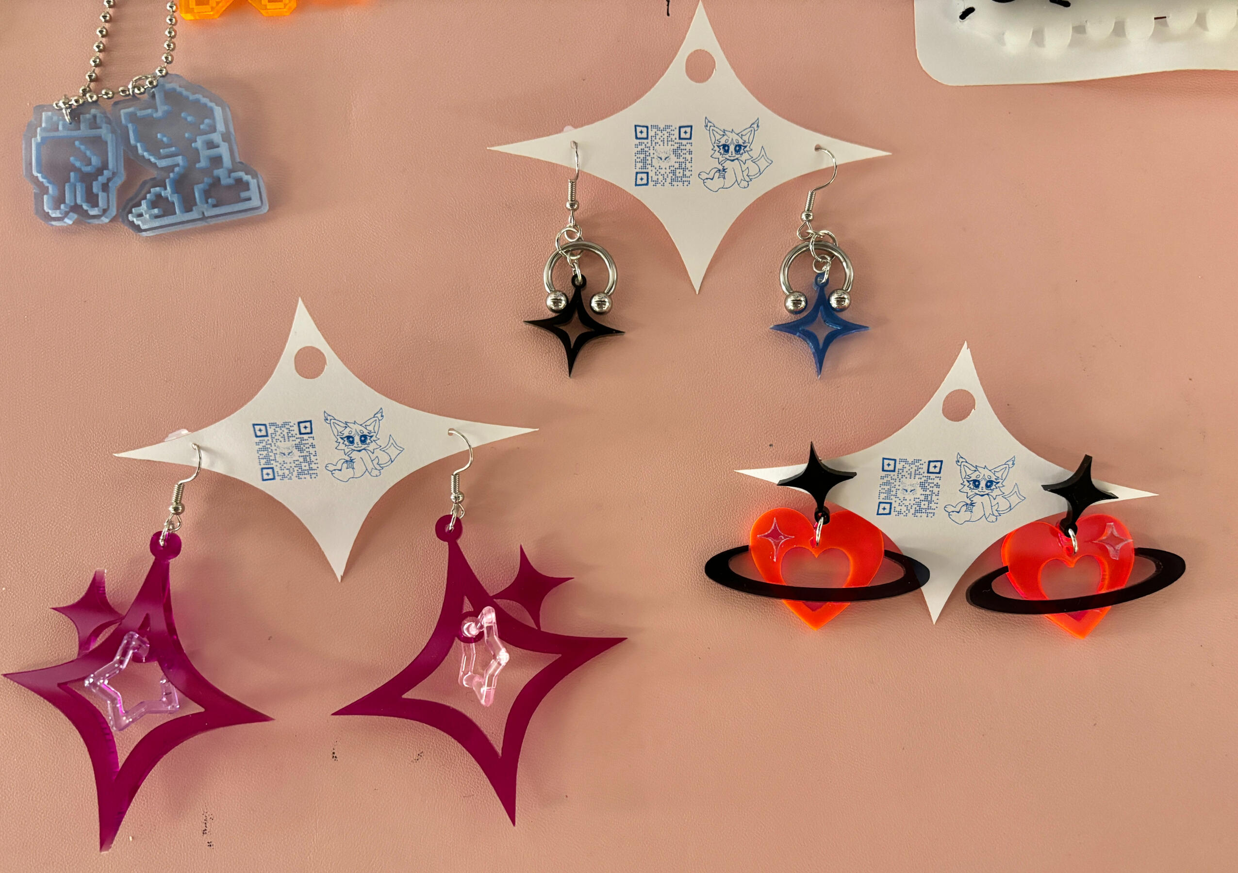 various earrings (metal, star, orbit) 2024 laser cut acrylic, jump rings, earring hooks, horseshoe barbells